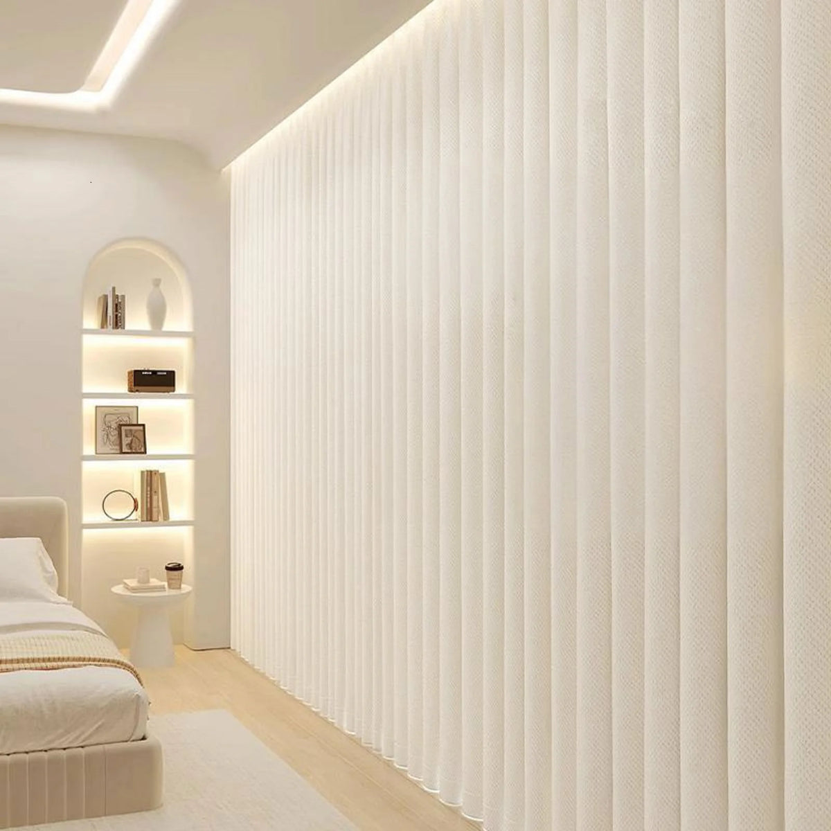 A vertical pleated white fabric room divider curtain with hooks in a modern interior setting.