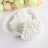 A white bowl holds 400 pearl flower stamens for DIY crafts and wedding decor.
