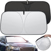 A black foldable windshield sun shade is shown open, with a white version displayed next to a car.
