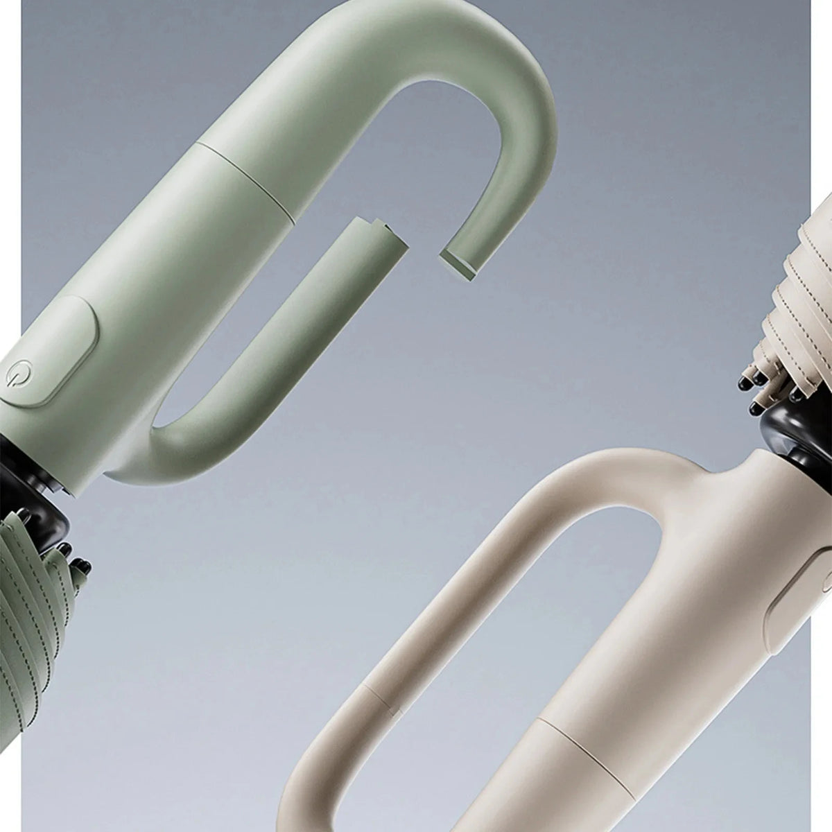 Close-up view of a light green windproof automatic folding umbrella handle and shaft.