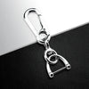 Silver metal split ring key fob cover with a loop and a small ring attached.