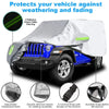 A silver car cover with reflective stripes protects a blue Jeep Wrangler against weathering and fading.
