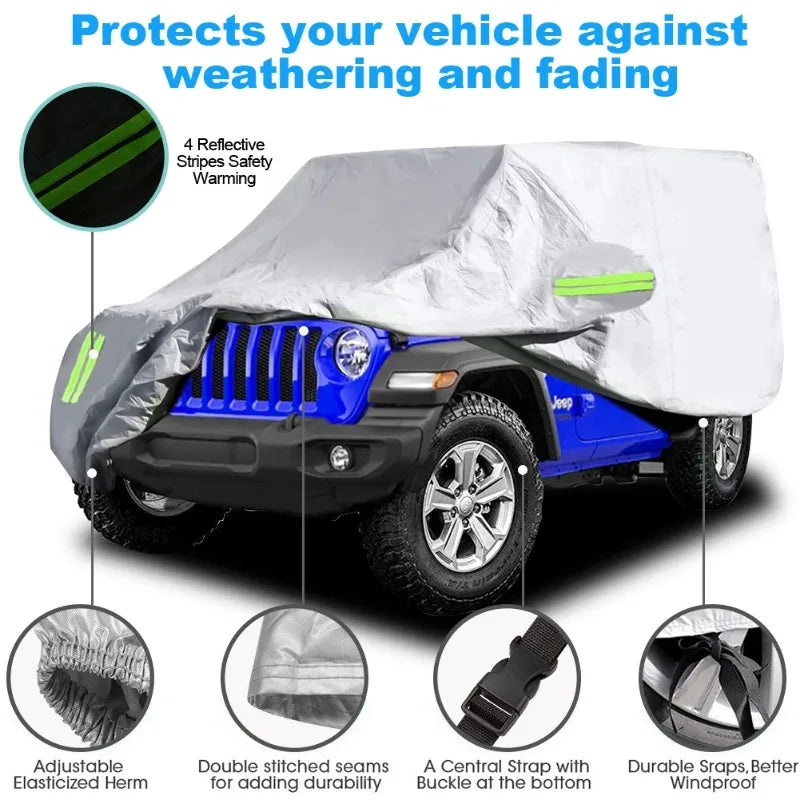 A silver car cover with reflective stripes protects a blue Jeep Wrangler against weathering and fading.