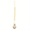 A light yellow silicone pacifier clip with a teether attached on a string.