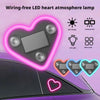Wiring-free LED heart atmosphere lamp illuminating a car window with pink and blue neon light.