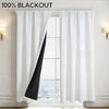 White blackout curtain panels hanging in a window frame