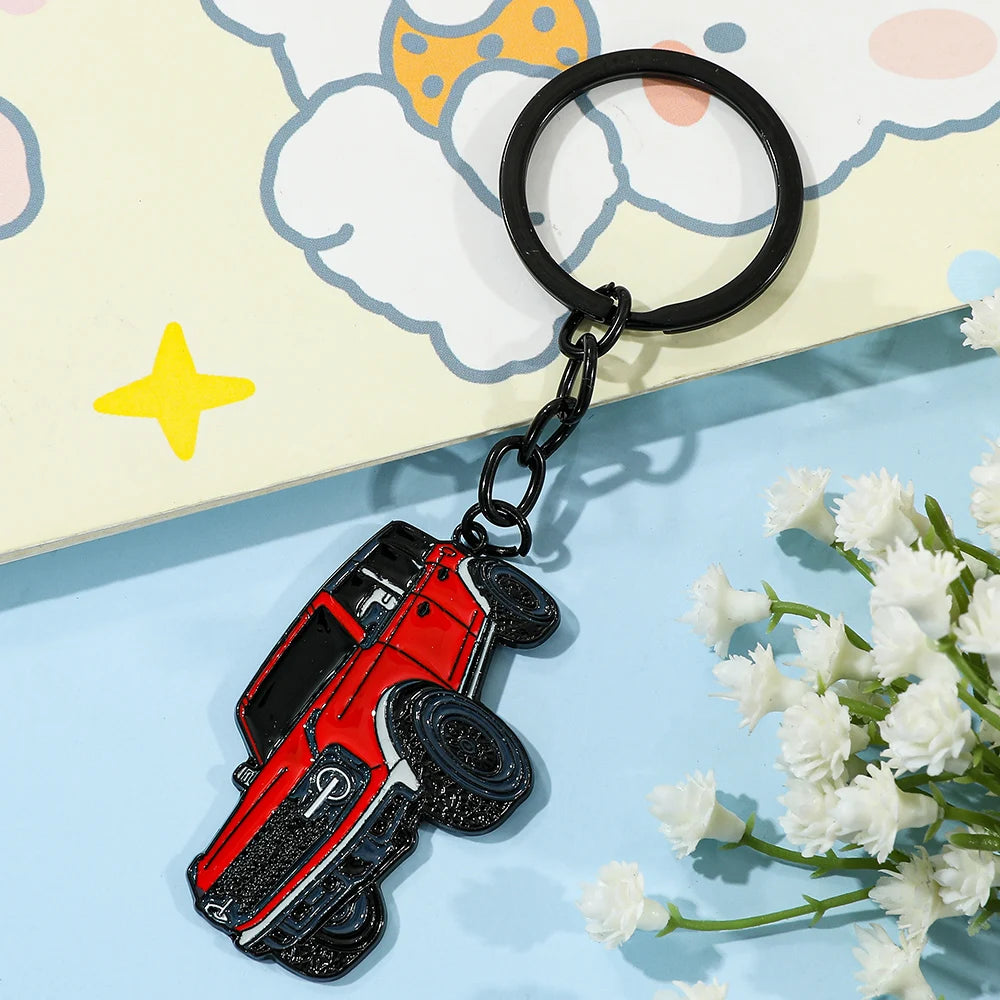 A red Ford Bronco zinc alloy keychain attached to a black ring, set against a light background.
