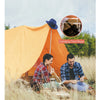 A man and a woman are sitting outside a yellow tent in a grassy field, with a close-up inset showing camping tent rope.