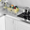 A kitchen counter displaying various glass bottles and a stainless steel pot on a silver countertop.