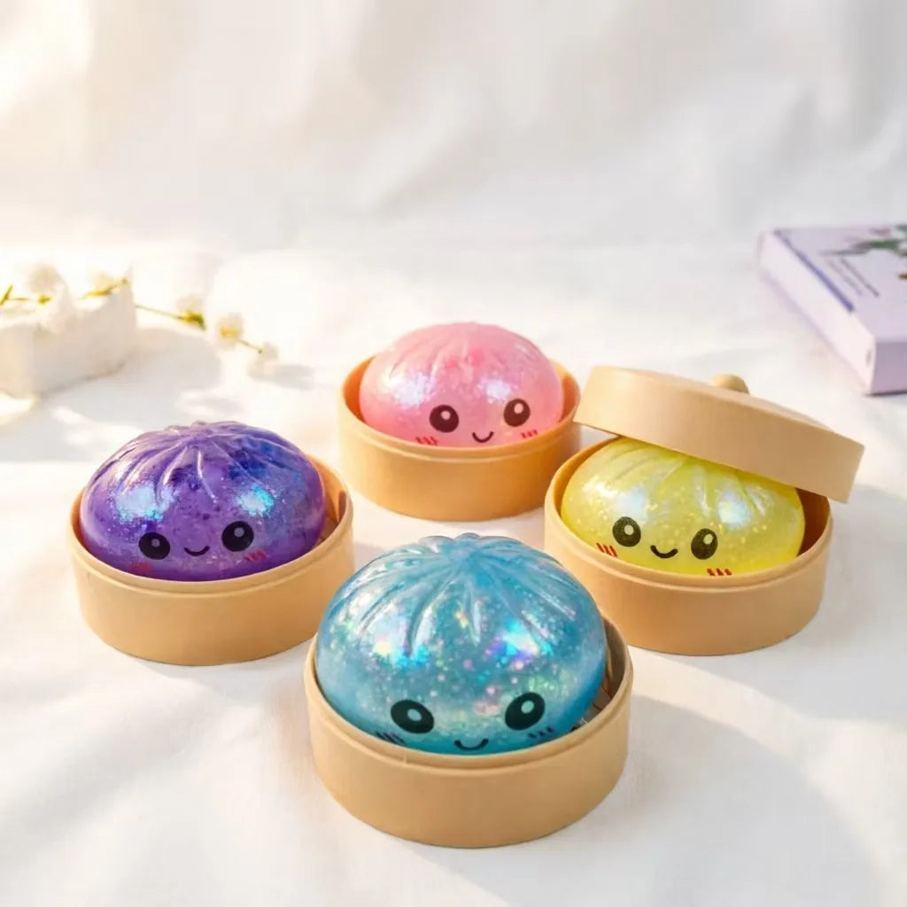 A set of four colorful glitter dumpling squeeze toys in natural wood containers on a white surface.