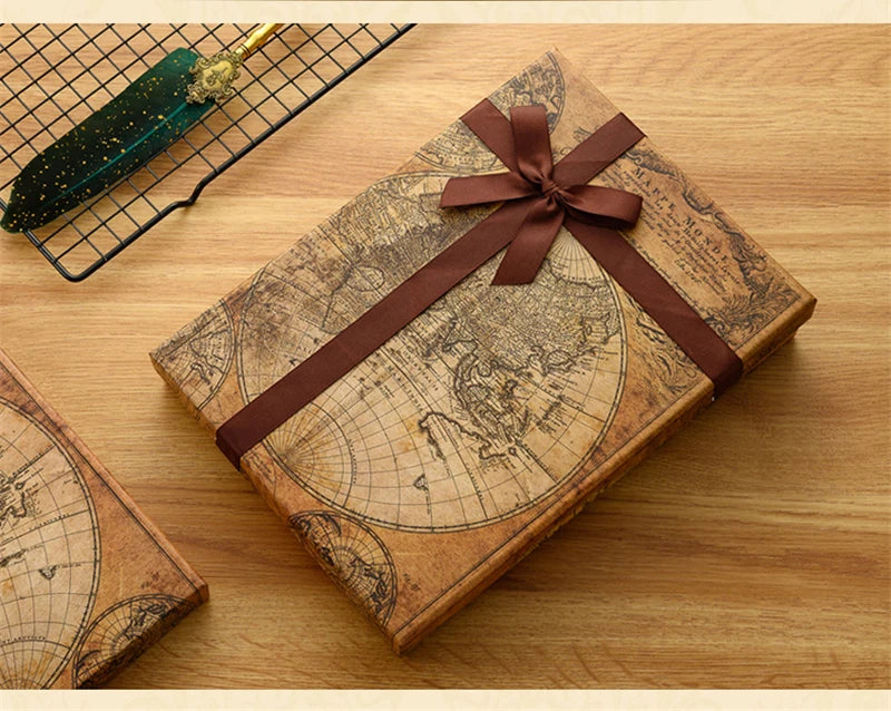 A vintage leather-bound map or document is shown on a wooden surface, tied with a brown ribbon, next to a metal grid and anot