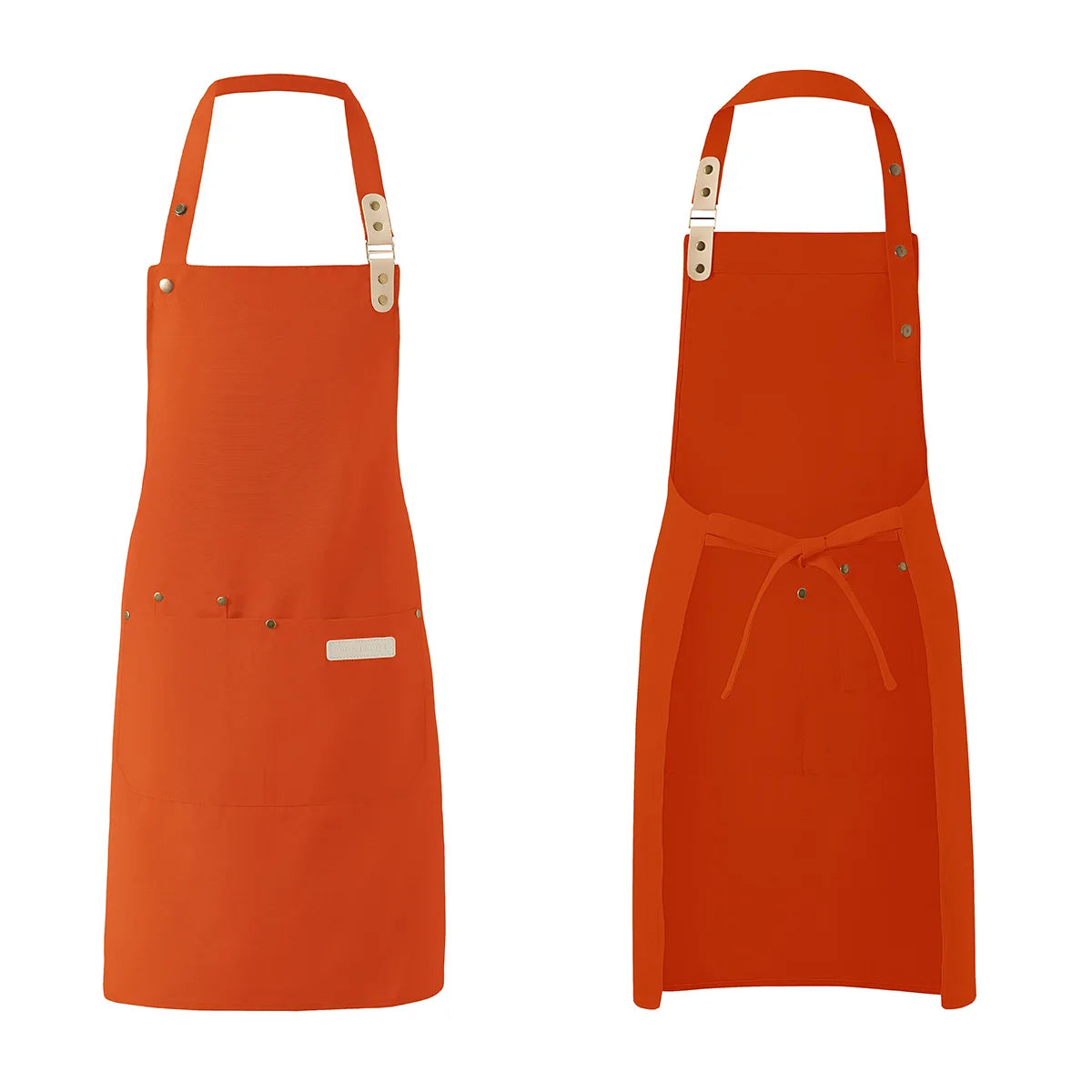 A bright orange waterproof canvas chef apron hanging against a white background.