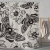 Gothic skull shower curtain featuring a black and white design of moths and floral patterns.