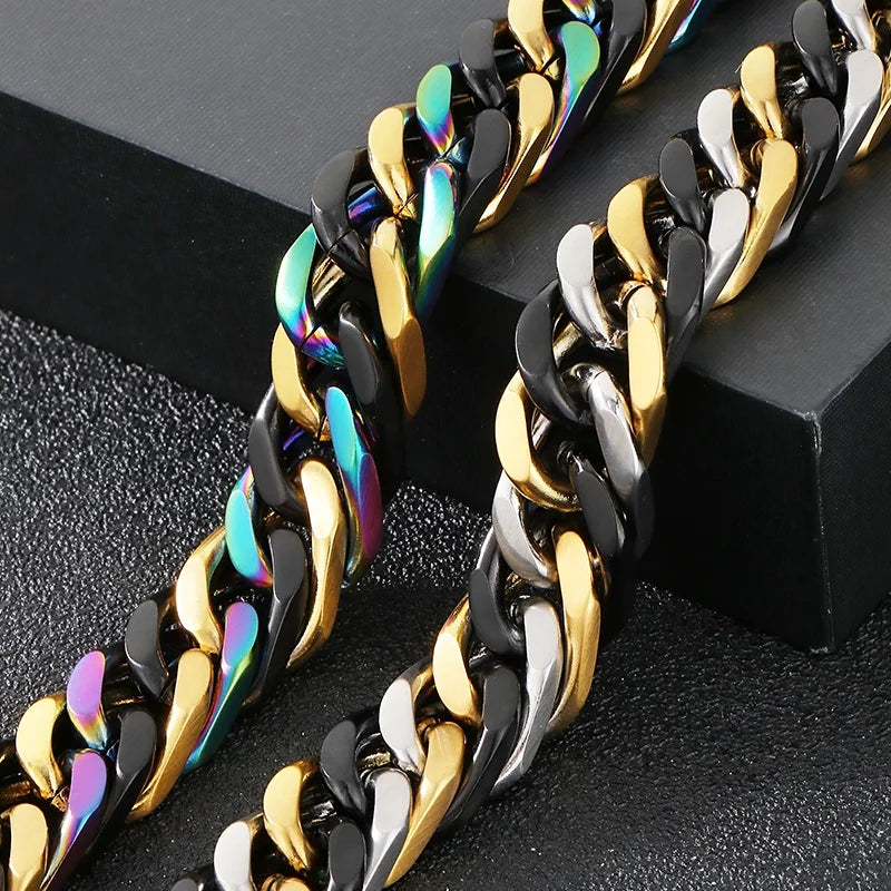A pair of chunky stainless steel Cuban chain bracelets featuring black and gold links with iridescent blue accents.