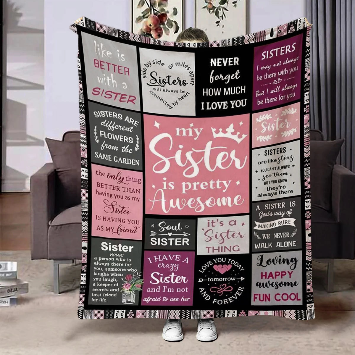 A black and pink flannel throw blanket featuring quotes about sisters and sisterhood.