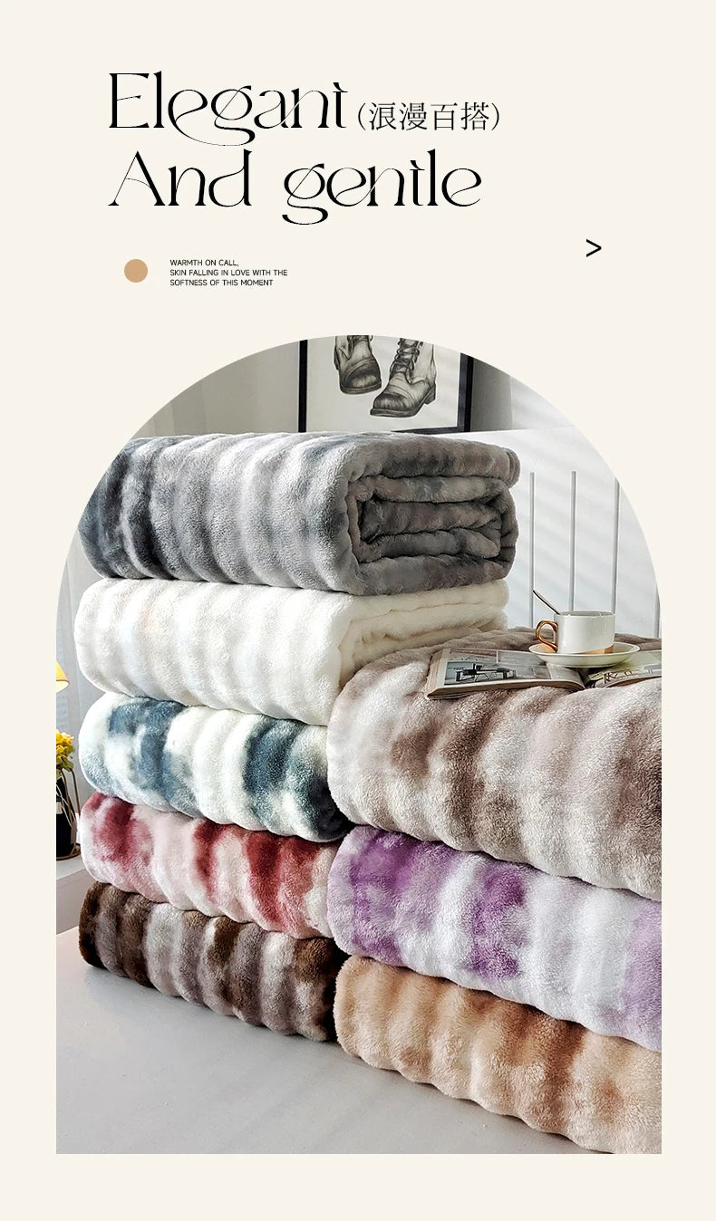 A stack of gradient bubble fleece throw blankets in various shades of gray, white, purple, and brown.