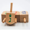 A set of wooden spinning tops used for Hanukkah and kids' play, featuring various designs.