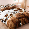 A bedding set featuring a Highland cow print duvet cover and pillowcases with brown and black patterns.