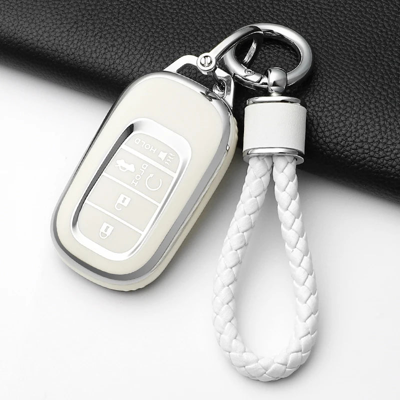 A white anti-scratch TPU protective case for a Honda key fob, attached to a silver keyring.