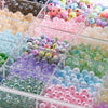 A collection of mixed colored 8mm acrylic beads in various shades and styles displayed in a clear blind box.