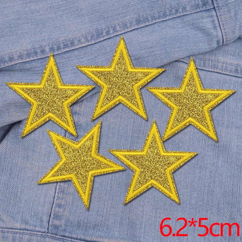 Set of five gold glitter star iron-on embroidered patches on a denim fabric.