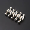 A cluster of silver neodymium magnetic pushpins arranged in a row.