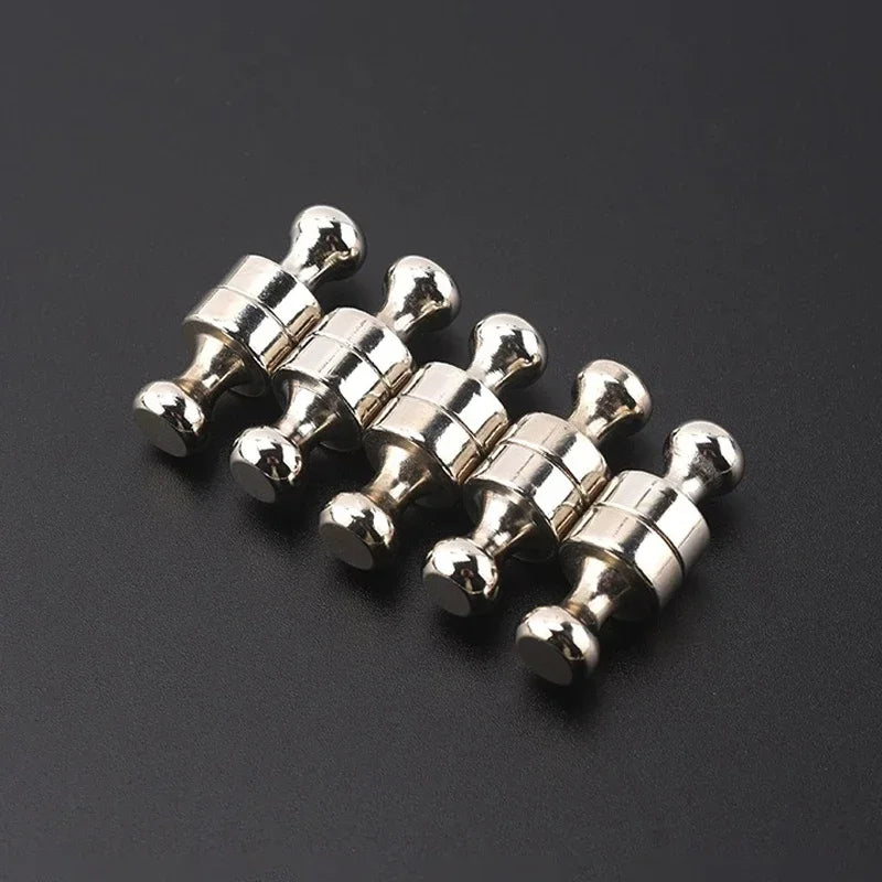 A cluster of silver neodymium magnetic pushpins arranged in a row.
