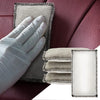 A hand in a white glove is holding a stack of dual-sided cleaning sponges on a dark purple car interior surface.