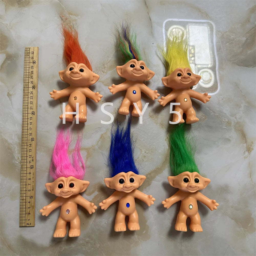 A collection of handcrafted troll doll figurines in various bright colors including orange, pink, blue, and green.