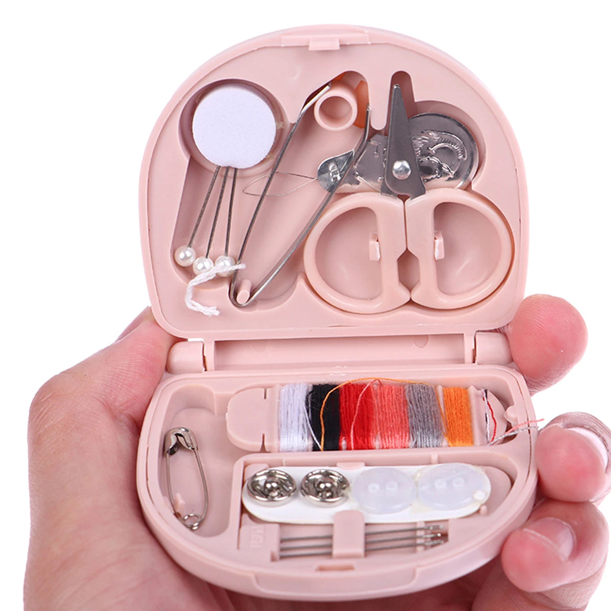 A pink portable mini sewing kit is shown open, displaying various sewing tools and colored threads.