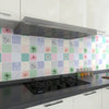 A modern kitchen featuring a stainless steel extractor hood above a speckled floral splashback wallpaper.