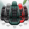A row of black, gray, green, and red universal car seat covers displayed for sale.