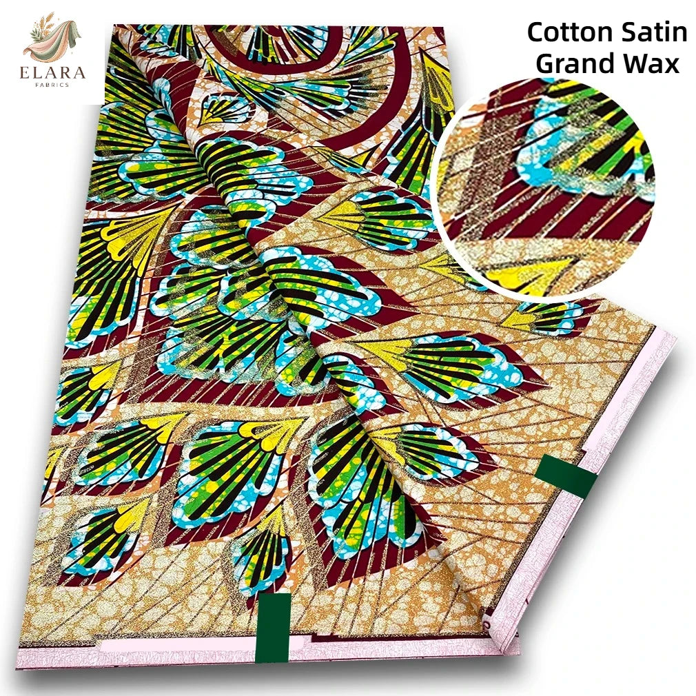 Cotton Satin Grand Wax fabric featuring a vibrant pattern of green, yellow, and blue leaves on a beige background.