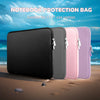 A set of four notebook protection bags or laptop sleeves in black, gray, pink, and purple are displayed on a sandy beach.