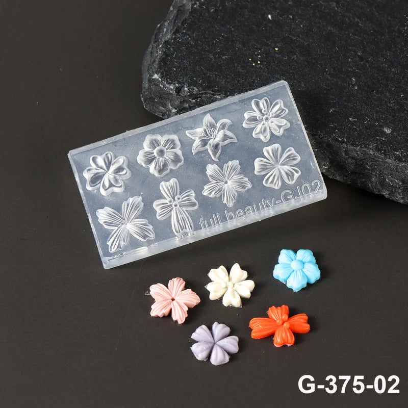 A clear silicone nail art mold with floral designs is displayed next to several colored silicone petals.