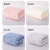 Four rolled microfiber towels in pink, white, blue, and gray colors displayed side by side.