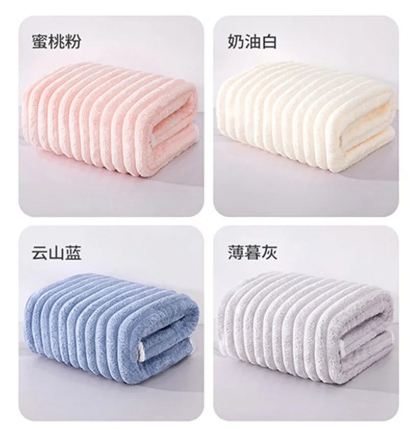 Four rolled microfiber towels in pink, white, blue, and gray colors displayed side by side.