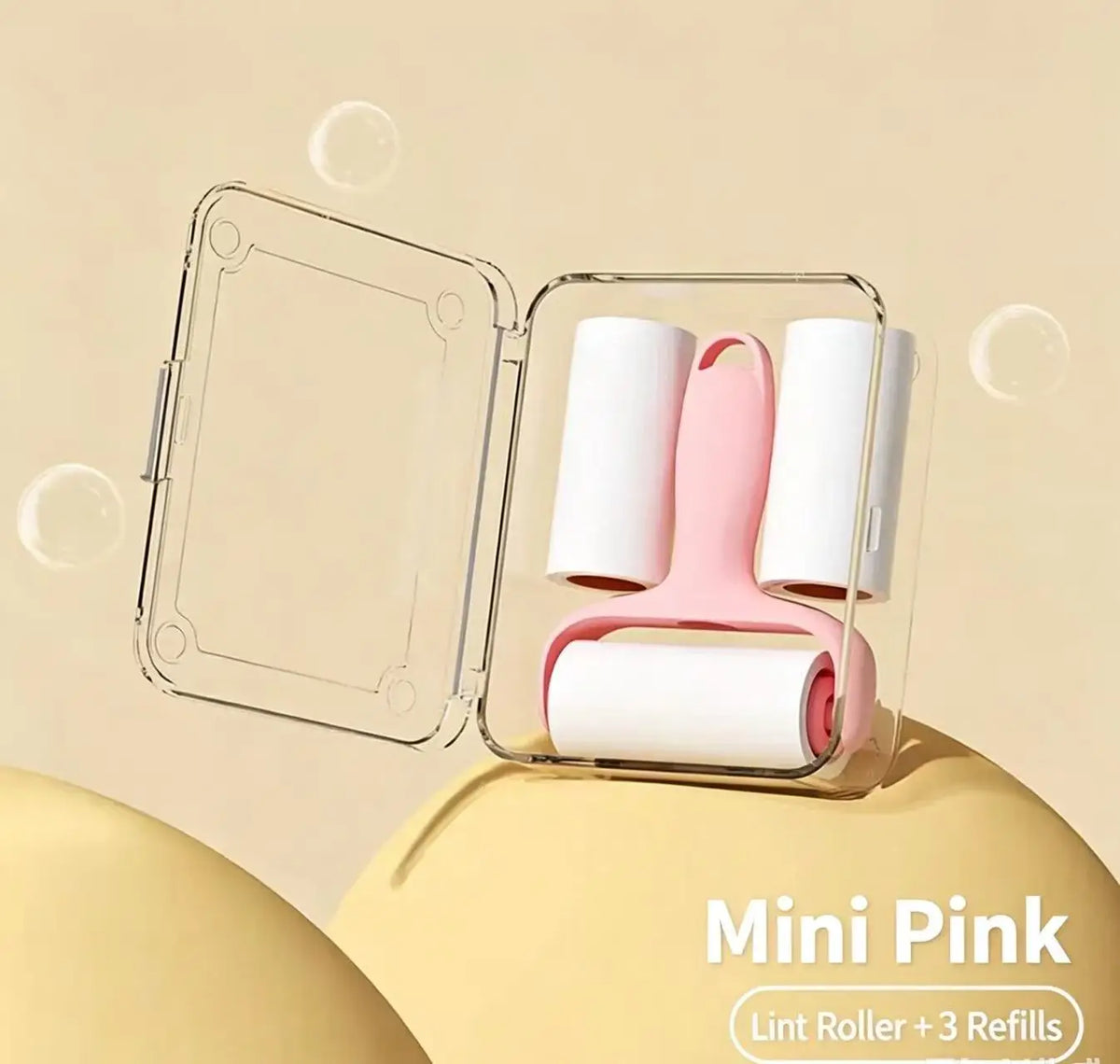 Mini Pink lint roller with three refills displayed in a clear plastic container.