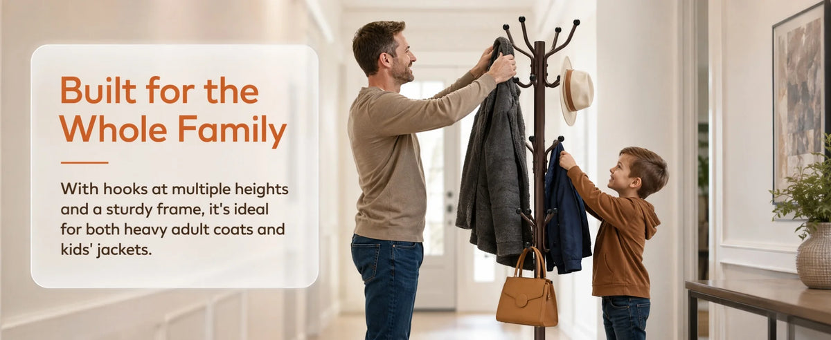 A man is hanging coats on a freestanding metal coat rack with multiple hooks in a bright hallway.