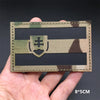 A rectangular tactical patch featuring a camouflage pattern and a national flag design with a shield emblem.