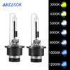 A pair of HID Xenon headlight bulbs with various color temperatures displayed next to a scale.