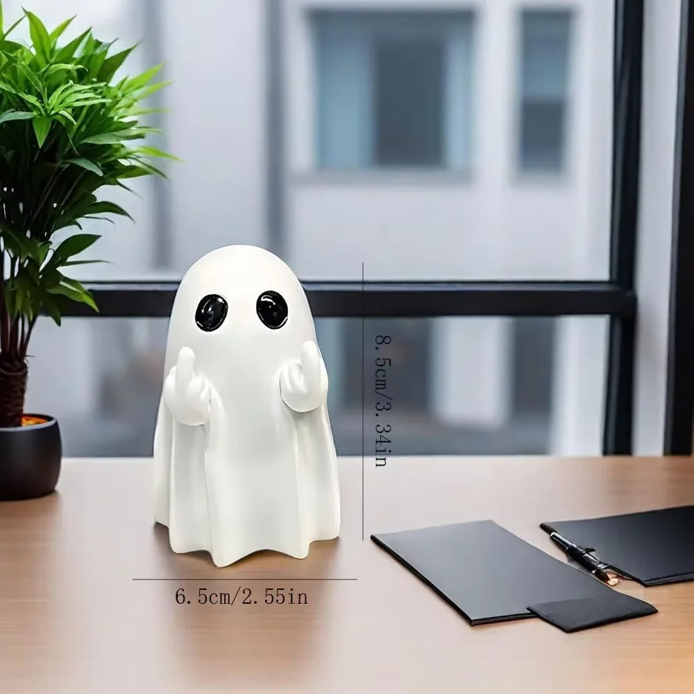 A white ghost resin statue with a middle finger gesture is displayed on a wooden table.