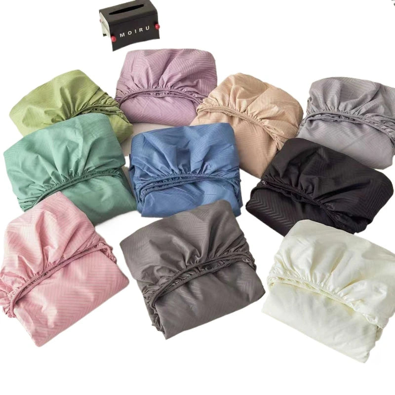 A collection of various colored fitted sheets made from brushed microfiber fabric, including pink, purple, green, blue, beige