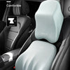 A light gray memory foam headrest and lumbar support pillow installed in a black car seat.
