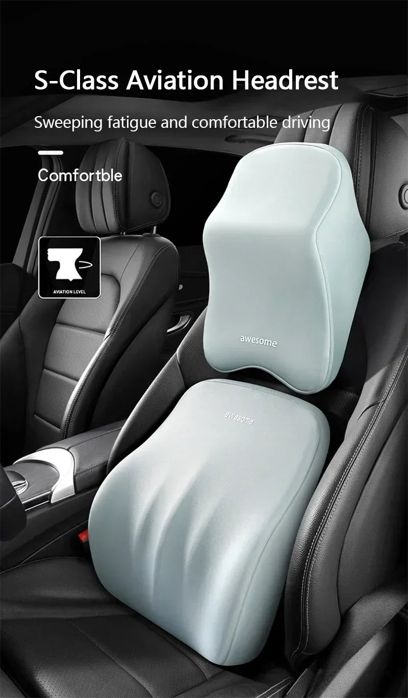 A light gray memory foam headrest and lumbar support pillow installed in a black car seat.