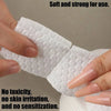 A hand is holding a white lint-free cotton round for nail care, demonstrating its soft and strong texture.