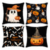 Un juego de cuatro fundas de almohada negras con diseños de Halloween, incluyendo fantasmas, murciélagos y calabazas.
