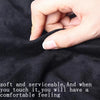 A hand is gently touching a piece of black suede fabric, highlighting its soft texture and comfort.