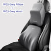 A grey memory foam car headrest and waist support pillow are shown inside a black car seat.
