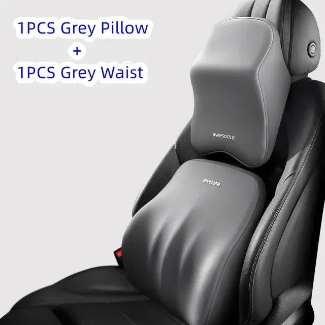A grey memory foam car headrest and waist support pillow are shown inside a black car seat.